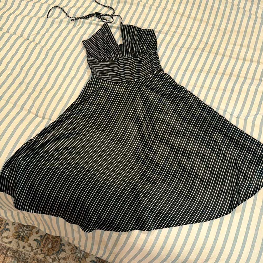 Elegant lusterous black and white striped midi dress with halter tie. Size 5/6